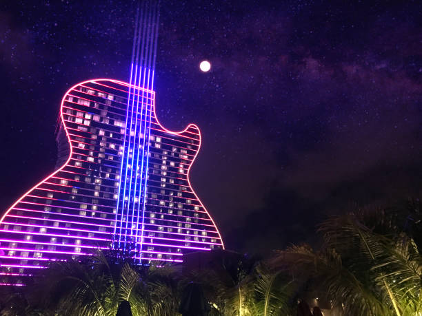 Hollywood - Fort Lauderdale, FL, USA - September 11, 2020: Colorful exterior general night view of the Hard Rock Cafe &amp; Casino guitar shaped hotel, the first guitar shaped hotel in the world. All nights the building turn on millions of lights, showing a spectacular light show on their facade.

This building is just one hour driving from Miami / Miami Beach, and two hours driving from Orlando and Disney's Theme Parks.